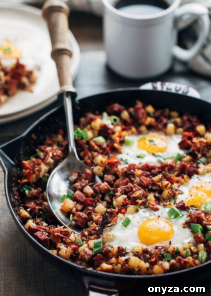 Hearty Corned Beef Hash and Eggs 2 Crispy corned beef hash and perfectly baked eggs in a cast iron skillet, ready for a comforting breakfast