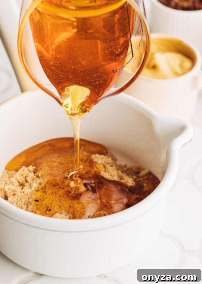 pouring honey into honey mustard glaze for ham