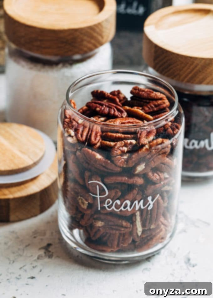 Stress-Free Pantry Organization You'll Love 4 pecans in wood-topped glass jars