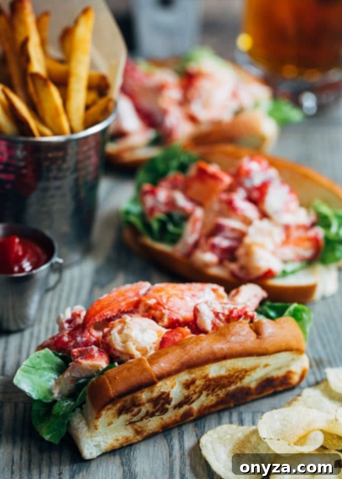 Two freshly prepared New England lobster rolls, showcasing the generous lobster salad in toasted, flat-sided buns, ready to be enjoyed as a classic summer meal.
