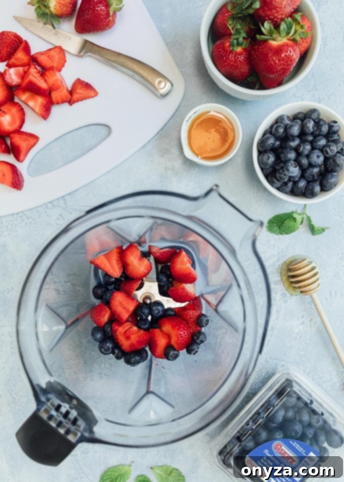 Fresh strawberries and blueberries blending for a homemade mixed berry vinaigrette