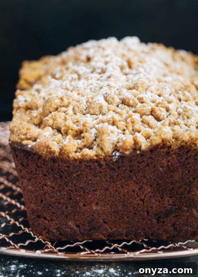 Close-up of golden pumpkin bread batter in a mixing bowl, showcasing its smooth and vibrant texture before baking.