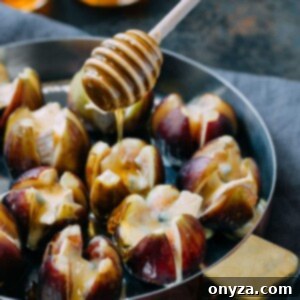 drizzling honey over baked Cambozola stuffed figs with a honey dipper