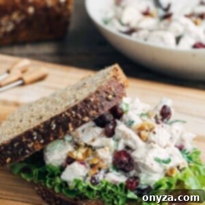 Cranberry Chicken Salad with Walnuts on whole grain bread, a close-up of the delicious sandwich filling.