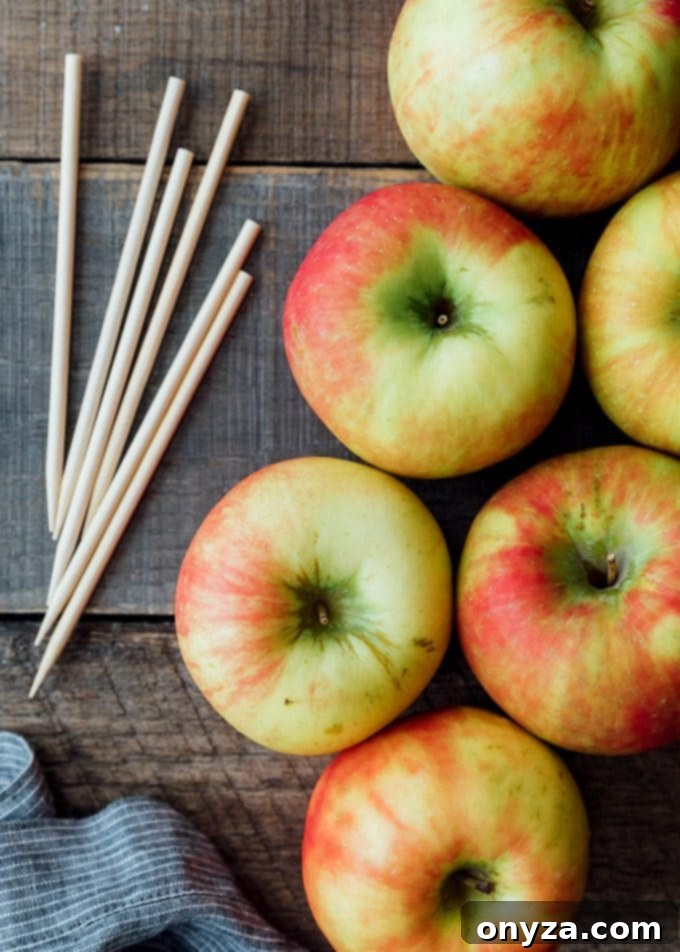 crisp Honeycrisp apples ready for dipping, arranged on a rustic board with wooden sticks