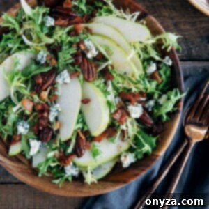 Pear salad with warm bacon vinaigrette in a wooden bowl, capturing its rustic elegance