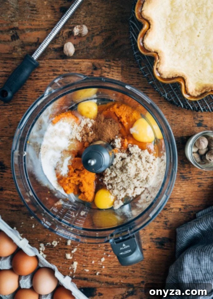 Velvet Pumpkin Custard Pie 2 ingredients for pumpkin custard pie in a food processor bowl