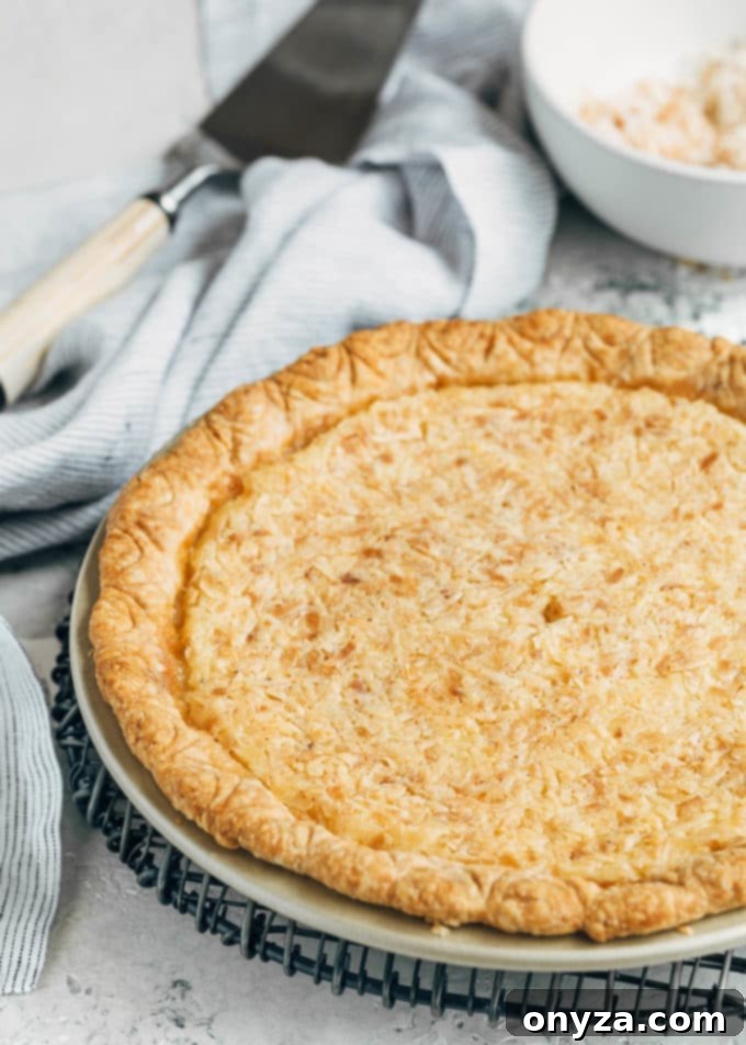 baked coconut custard pie on a cooling rack