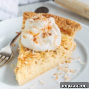 slice of coconut custard pie on a plate with whipped cream and toasted coconut flakes
