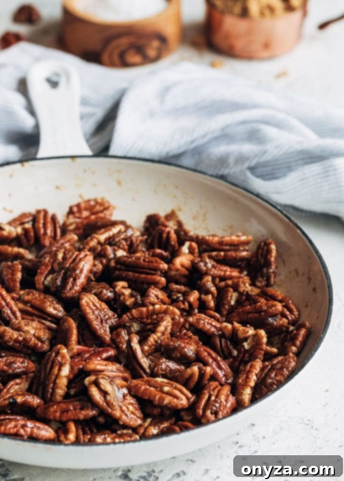 Stovetop Caramel Crunch Pecans 2 Caramelized pecans in a white saute pan