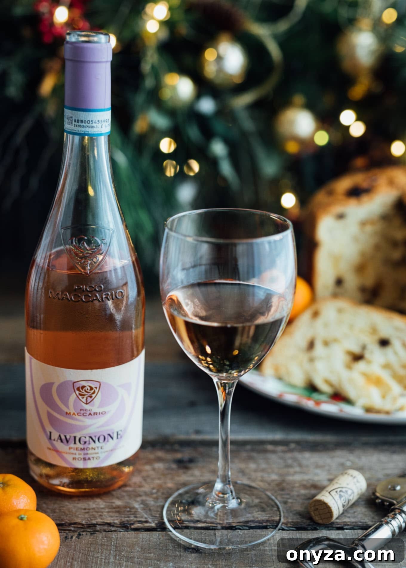 Glass of Pico Maccario Barbera ‘Lavignone’ rosé wine with a poured glass and a slice of panettone, showcasing a delightful holiday pairing