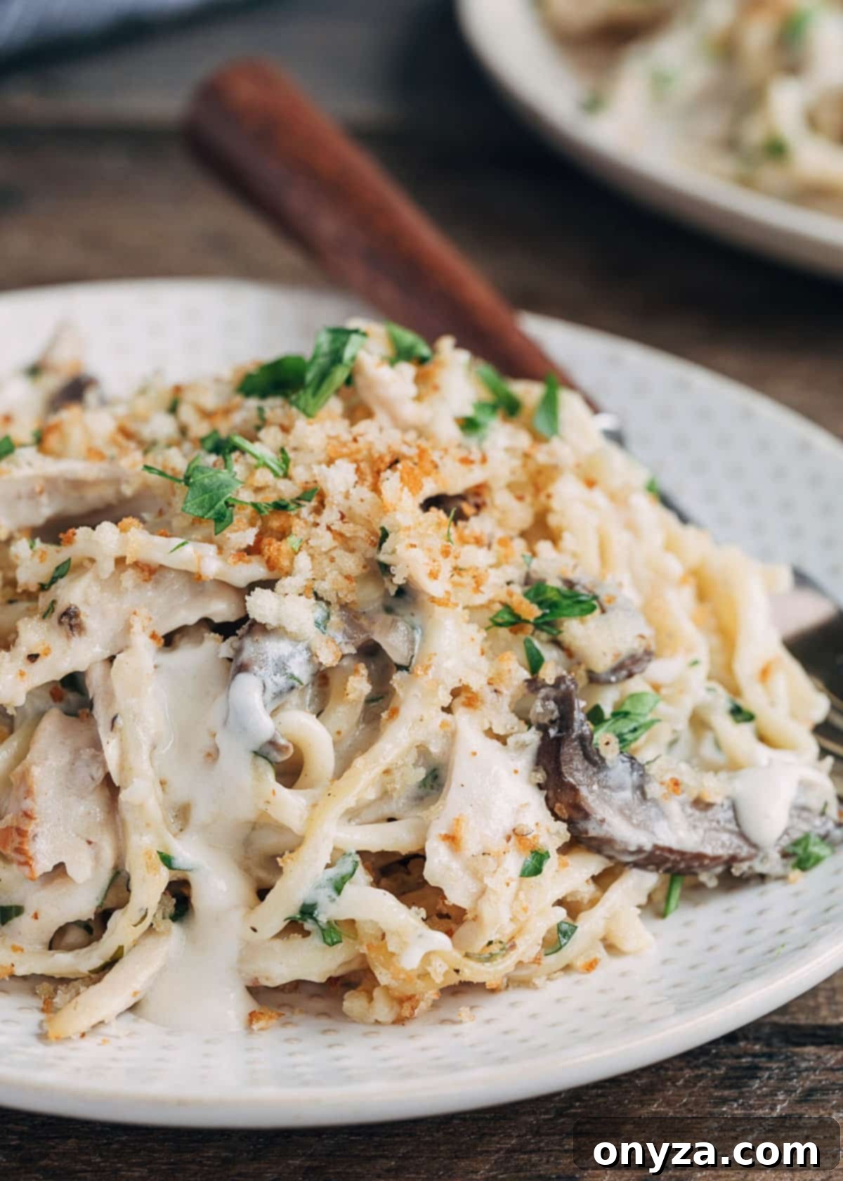 Creamy Turkey Tetrazzini 8 closeup of turkey tetrazzini on a plate with mushrooms and peas
