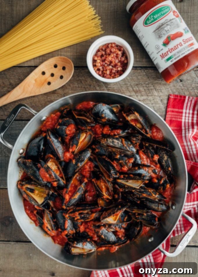 San Marzano Mussel Pasta 4 Fresh mussels simmering perfectly in rich La Regina di San Marzano tomato sauce in a pan