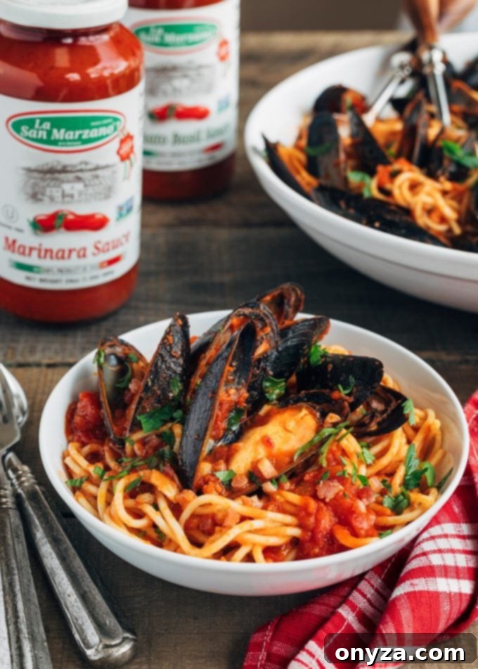 San Marzano Mussel Pasta 6 A generous serving of spaghetti with mussels and rich La Regina di San Marzano pasta sauce