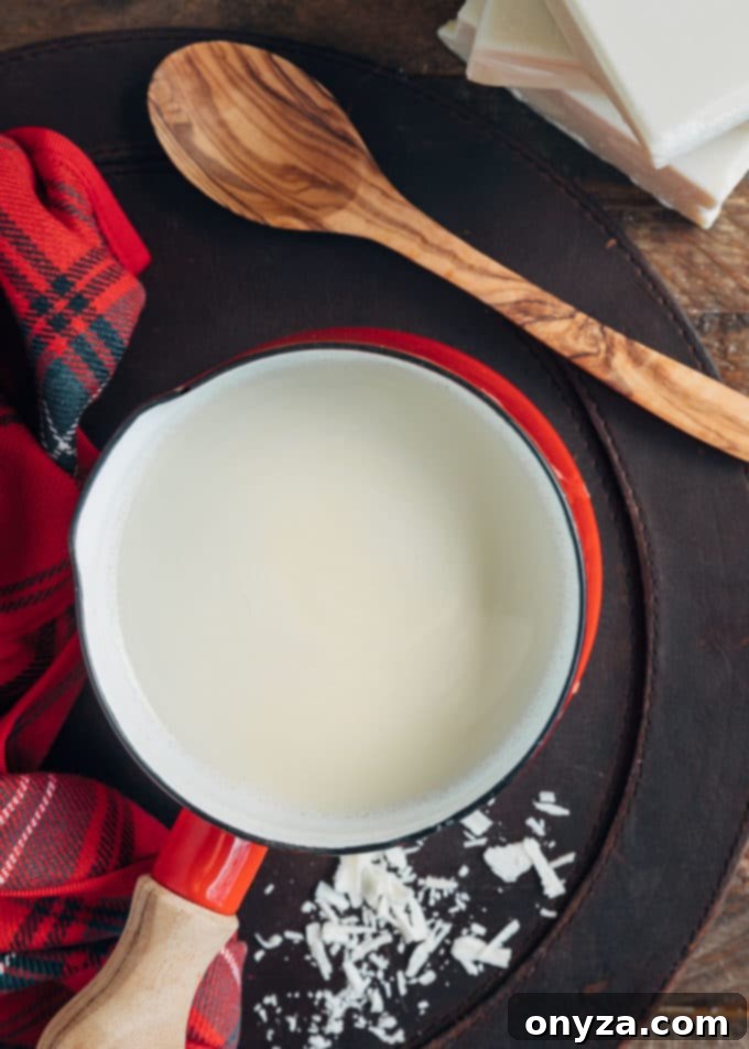 pot of white hot chocolate with a wood spoon