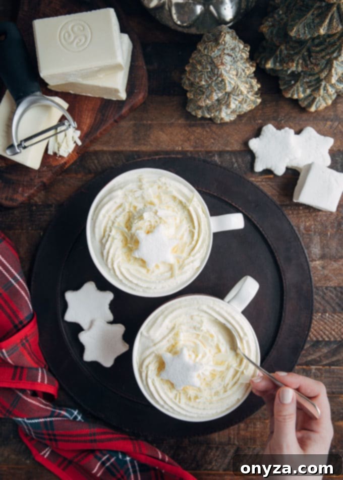 overhead view of mugs of white hot chocolate with whipped cream