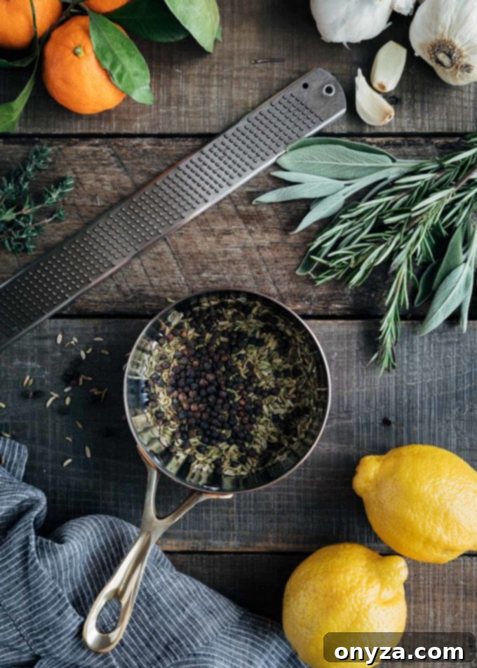 Perfectly Crispy Porchetta 3 Fennel seeds and peppercorns in a pot for a porchetta dry rub, with oranges and lemon halves.