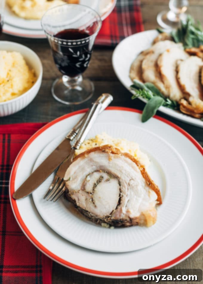 Perfectly Crispy Porchetta 7 Sliced porchetta on a plate with polenta, ready to be served.