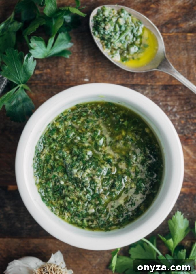 A pristine white bowl filled with vibrant green Italian salsa verde, garnished with fresh parsley sprigs, capturing its fresh and herbaceous essence, ready to complement a rich porchetta sandwich.