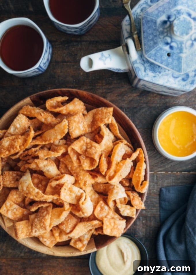 Crispy Fried Wonton Strips 7 overhead view of crispy wonton strips with dipping sauces and cups of tea