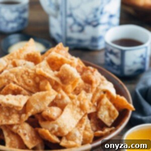 Crispy Fried Wonton Strips 8 crispy fried wonton strips in a bowl with duck sauce and cups of tea
