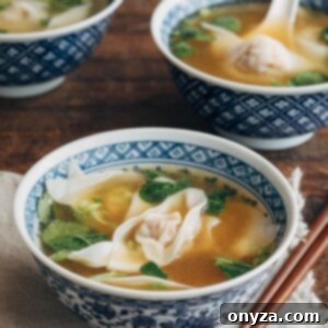 wonton soup in blue floral printed bowls with wooden chopsticks