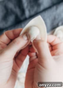 wonton wrapper with middle cinched around filling