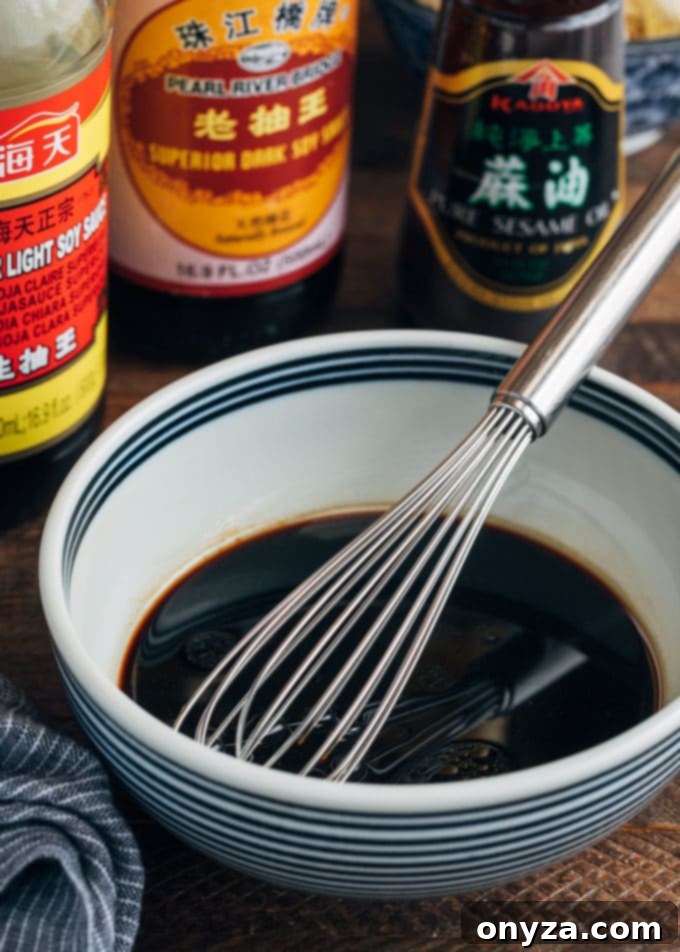 Shrimp Lo Mein 4 A bowl filled with the prepared lo mein sauce, with a whisk resting inside, ready for the stir-fry.