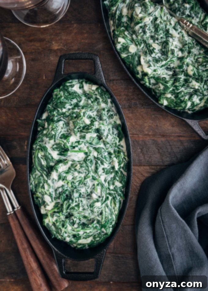 Several oval gratins filled with perfectly cooked creamed spinach, ready to be served.