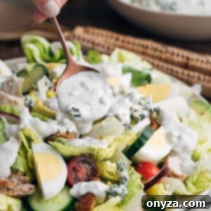 Creamy Buttermilk Blue Cheese Dressing 6 Homemade blue cheese dressing being drizzled over a vibrant house salad.
