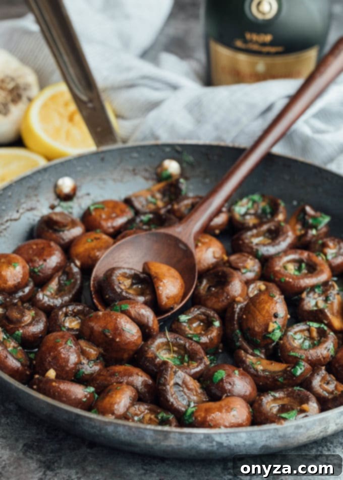 Sautéed mushrooms sizzling in a skillet with fresh parsley, capturing the cooking process.