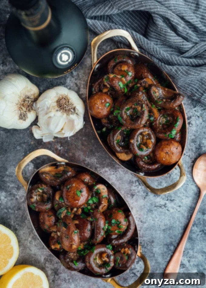 Small serving dishes of sautéed cremini mushrooms with garlic butter and fresh herbs, ready to be enjoyed as a gourmet side.
