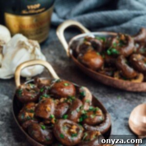 Sautéed mushrooms with garlic and cognac in small copper gratin dishes