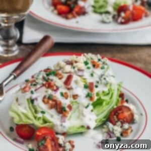 classic wedge salad with iceberg lettuce, bacon, and blue cheese dressing on a plate