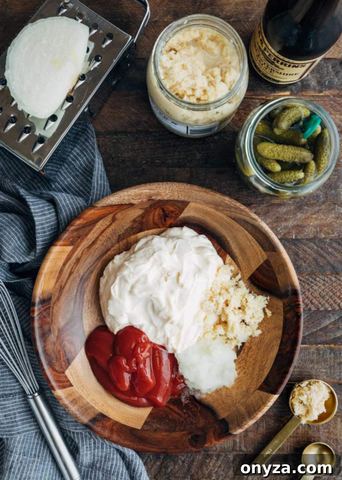 Overhead photo showing all the fresh ingredients for Russian dressing laid out in a wooden bowl before mixing