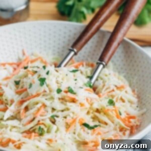 Creamy Homemade Deli Coleslaw 7 homemade coleslaw in a bowl with wooden serving spoons
