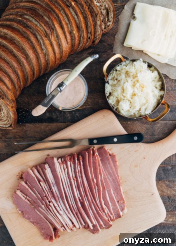 Homemade Reuben Sandwich Perfection 2 Sliced corned beef beautifully arranged on a wooden board, accompanied by small bowls of tangy sauerkraut and creamy Russian dressing