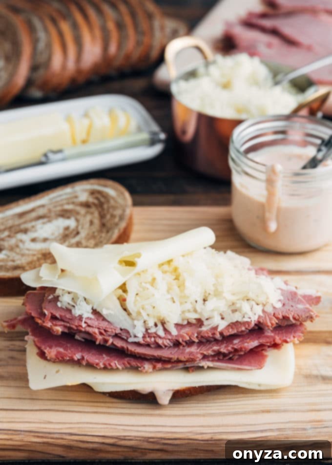 Homemade Reuben Sandwich Perfection 3 A perfectly prepared Reuben sandwich, ready for grilling, showcasing its neatly layered ingredients: corned beef, Swiss cheese, and sauerkraut