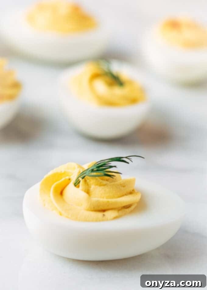 classic deviled eggs with dill on a marble board