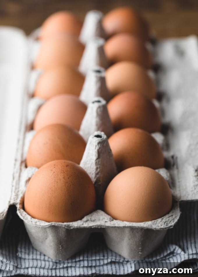 A dozen fresh brown eggs nestled in a rustic carton, ready for making delicious deviled eggs.
