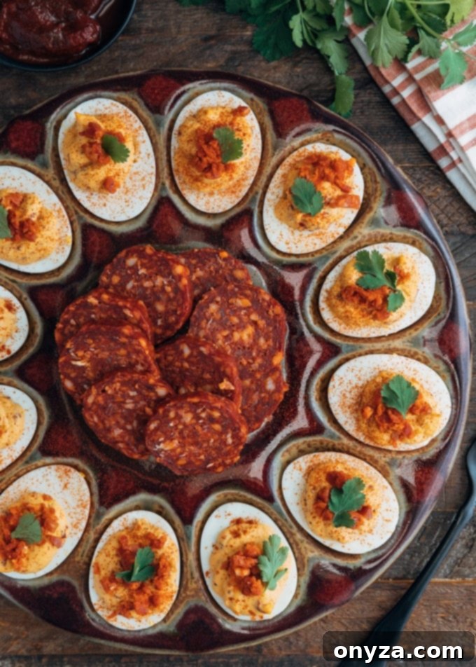 platter of chipotle deviled eggs with slices of chorizo sausage