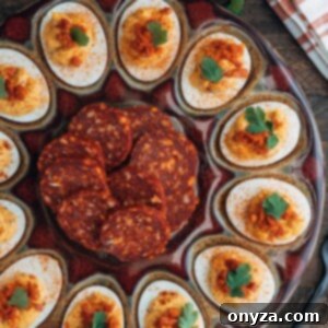 platter of chipotle deviled eggs with slices of chorizo sausage