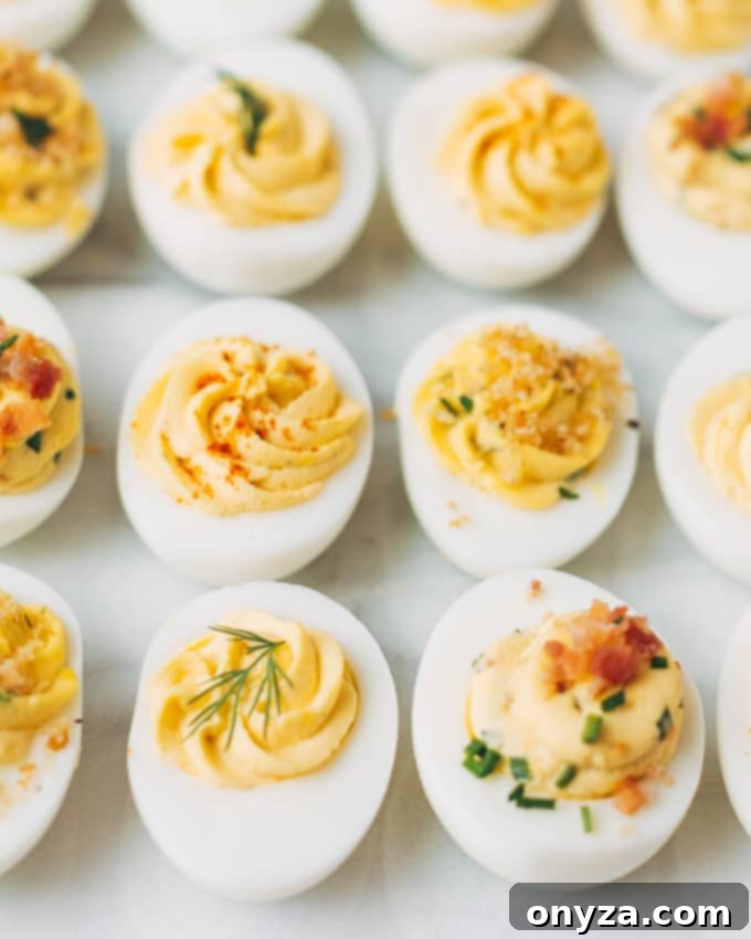 A close-up photograph of a single beautifully garnished deviled egg on a rustic background, highlighting its creamy filling