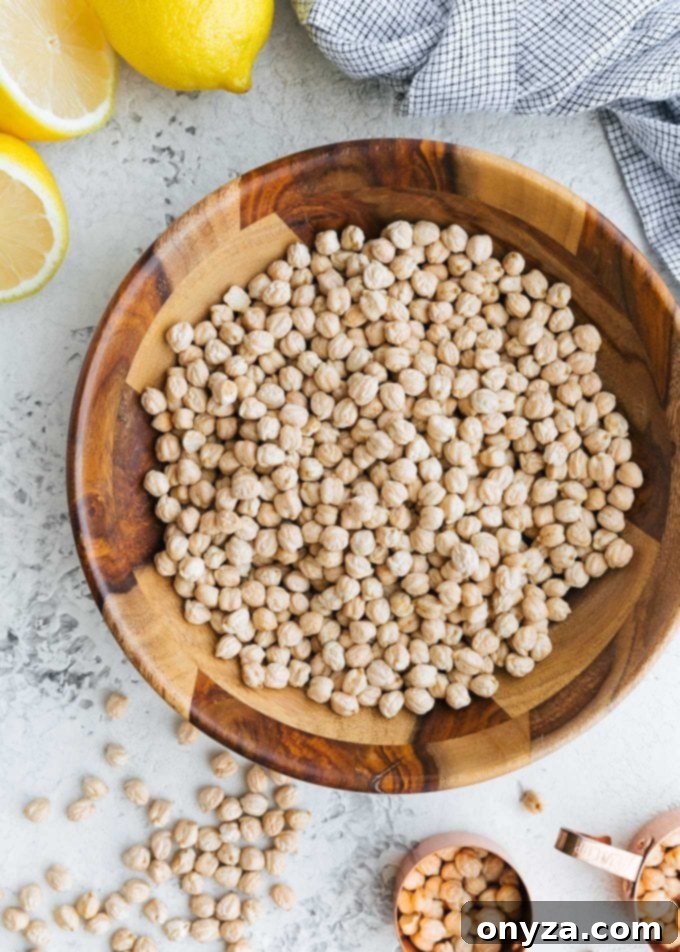 Mediterranean Chickpea & Feta Salad 2 Dried chickpeas in a rustic wooden bowl, ready for preparation into a delicious garbanzo bean salad.