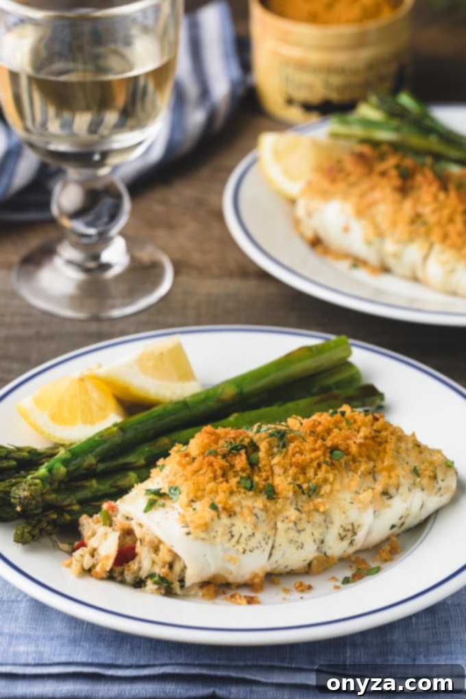 Elegantly plated crab stuffed flounder with asparagus, featuring blue-rimmed white dishes. Sponsored content.