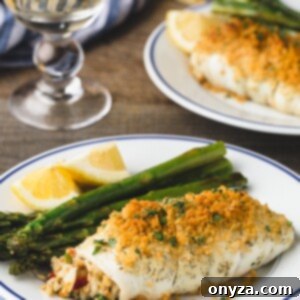 Crab stuffed flounder with asparagus on blue-rimmed white plates