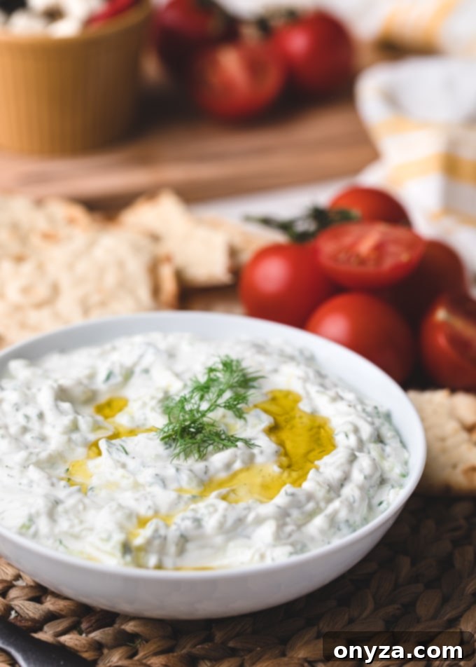 Creamy Homemade Tzatziki 5 Close-up shot of a bowl of homemade Tzatziki sauce, beautifully garnished with a swirl of extra virgin olive oil and fresh dill sprigs.
