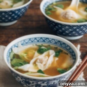 wonton soup in blue floral printed bowls with wooden chopsticks