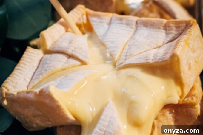 A perfectly ripe and oozy wheel of Pont L'Eveque PDO cheese, a classic soft washed rind