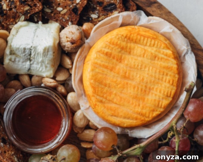 A beautifully composed cheese board featuring a round of Epoisses, fresh fruits, and nuts